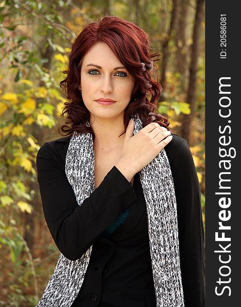 A Young Caucasian woman poses for portrait in an Autumn Setting. A Young Caucasian woman poses for portrait in an Autumn Setting.