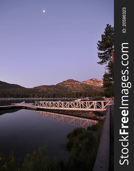 Dock on a calm lake with reflection