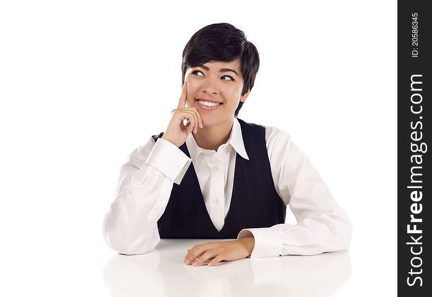 Attractive Smiling Mixed Race Young Adult Female At White Table Looking Up and Away on a White Background. Attractive Smiling Mixed Race Young Adult Female At White Table Looking Up and Away on a White Background.