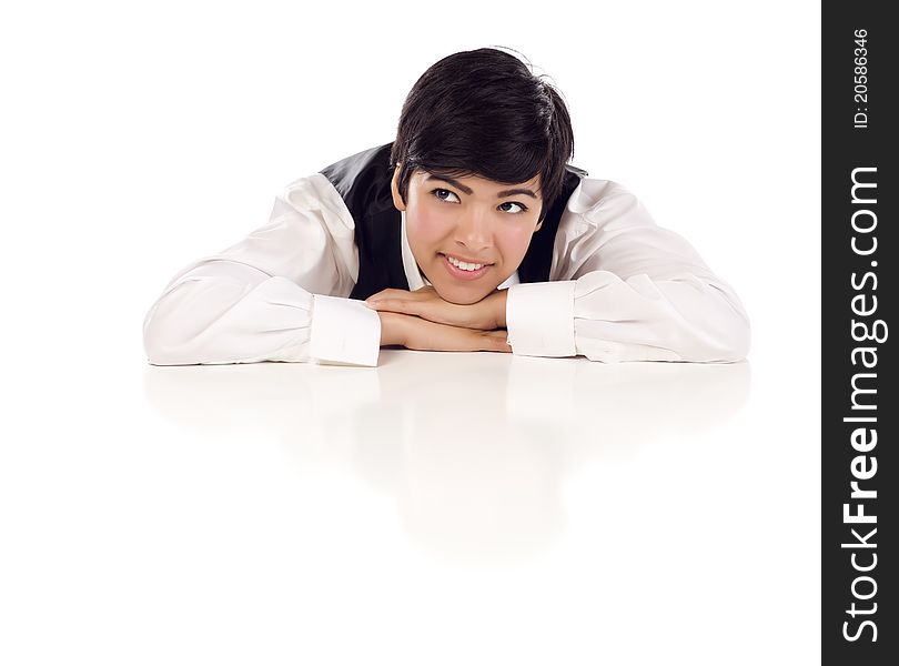 Attractive Smiling Mixed Race Young Adult Female Looking Up and Away Sitting At White Table Resting Her Head on Her Hands on a White Background. Attractive Smiling Mixed Race Young Adult Female Looking Up and Away Sitting At White Table Resting Her Head on Her Hands on a White Background.