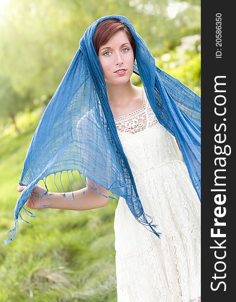 Outdoor Portrait of Pretty Blue Eyed Young Red Haired Adult Female with Blue Scarf. Outdoor Portrait of Pretty Blue Eyed Young Red Haired Adult Female with Blue Scarf.