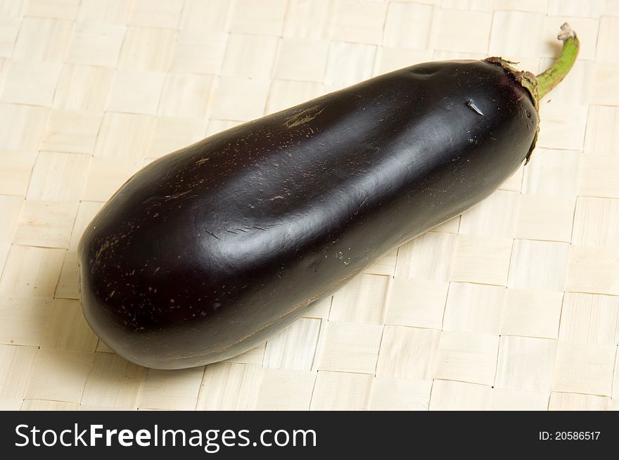 One eggplant on wicker table