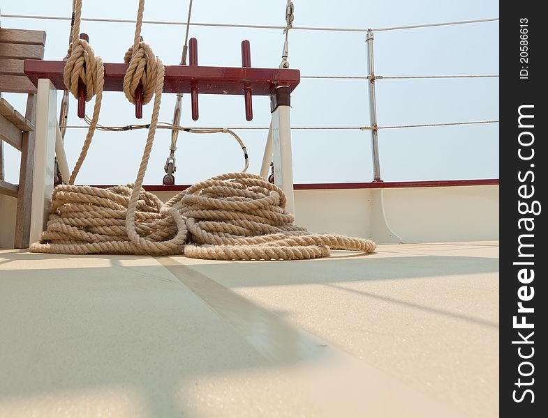 View of the coiled rope rigging on a sailboat deck.