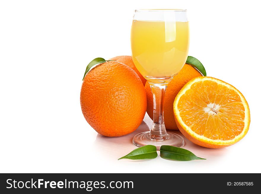 Orange juice in glass and fruits isolated on a white background