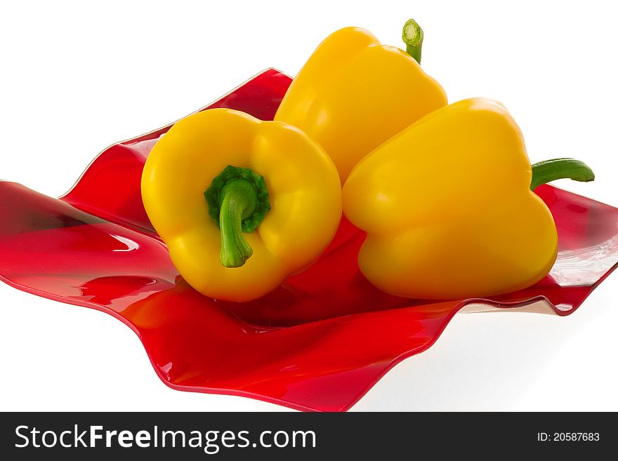 Yellow Bell Pepper On A Red Plate.