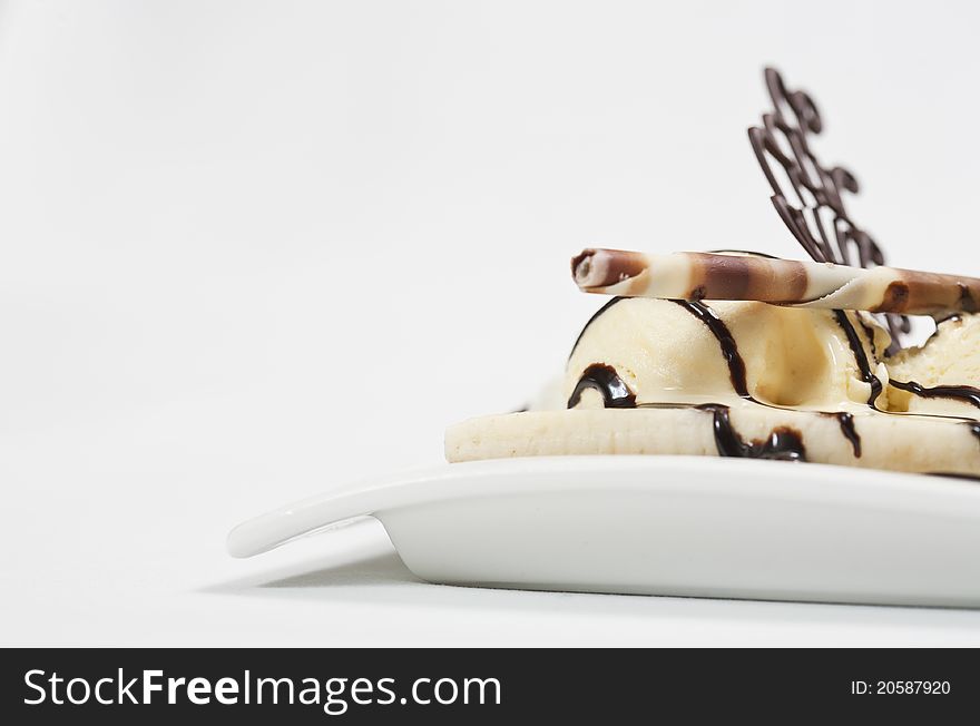 Cold and fresh ice cream dessert with lot of chocolate, and vanilla ice,on a white blow before a white background. Cold and fresh ice cream dessert with lot of chocolate, and vanilla ice,on a white blow before a white background