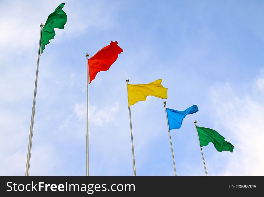 All sorts of color flags in blue sky