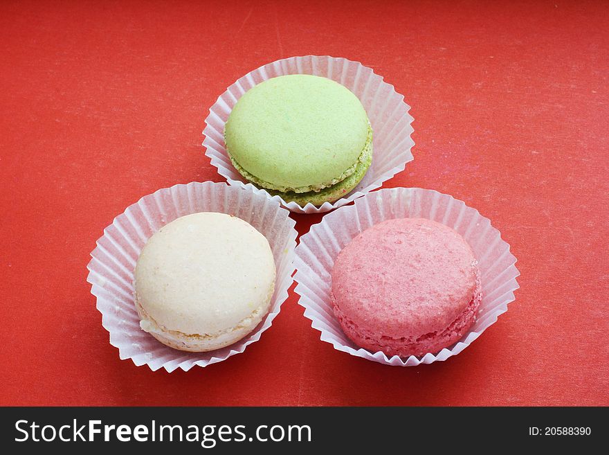 Multi Colored macaroon on the red background