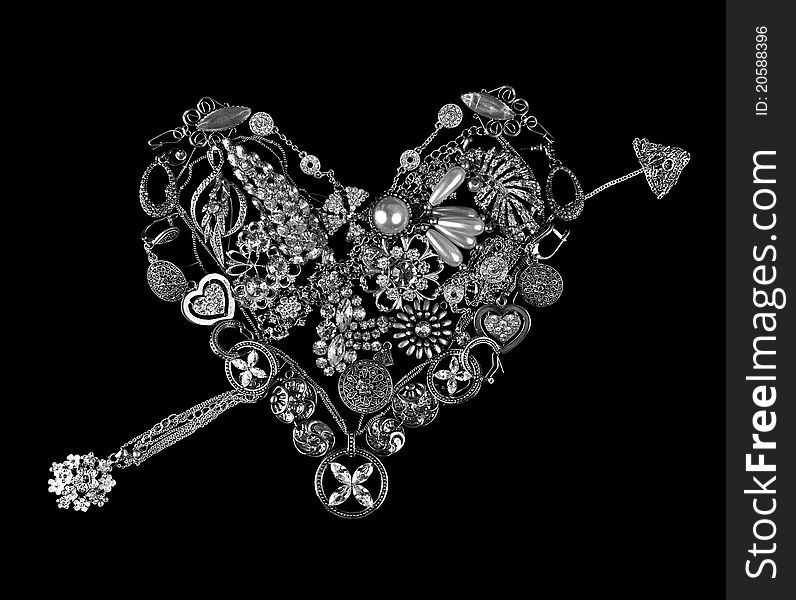 Gemstone heart with an arrow on black background