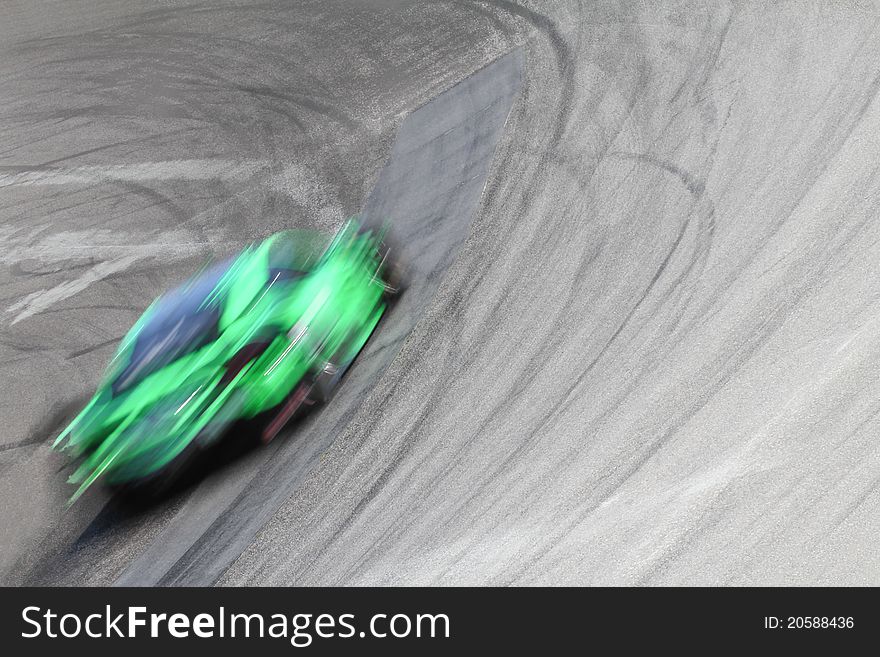 Speeding green race car in a fast corner. Speeding green race car in a fast corner