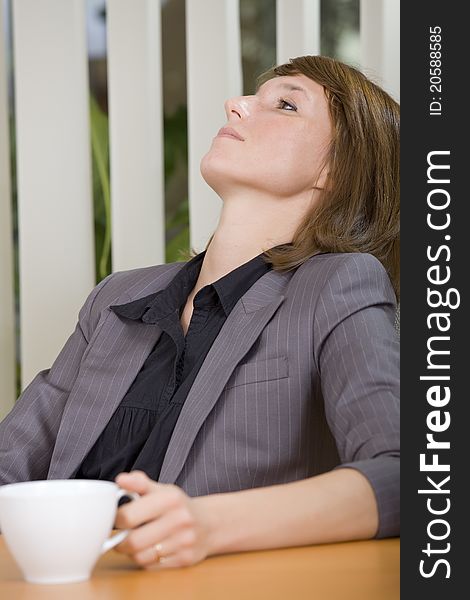 Coffee break in office - relaxing woman with cup tea. Coffee break in office - relaxing woman with cup tea