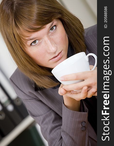 Woman Having Coffee Break At Office