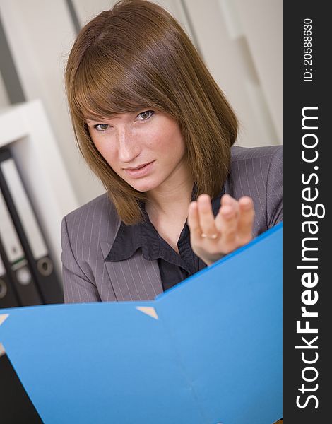 Young businesswoman holding file and discussing by office work. Young businesswoman holding file and discussing by office work
