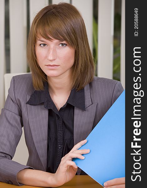 Portrait of businesswoman holding a file in office. Portrait of businesswoman holding a file in office