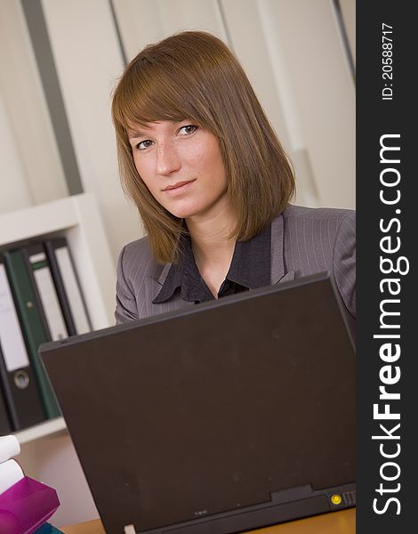 Young woman secretary by office work