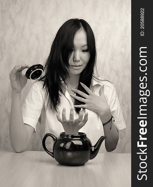 Girl and teapot at the table
