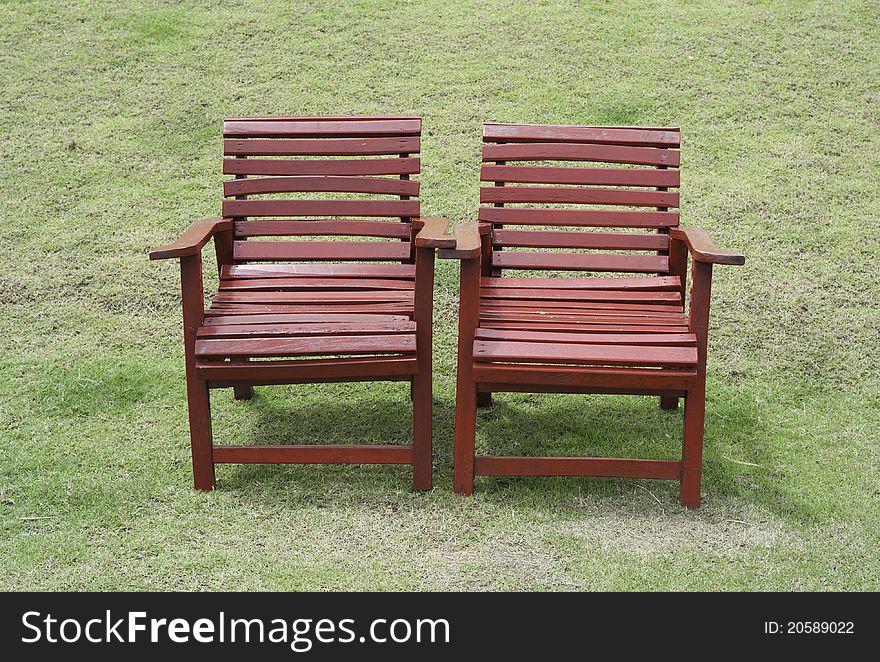 Two Red Chairs In Garden