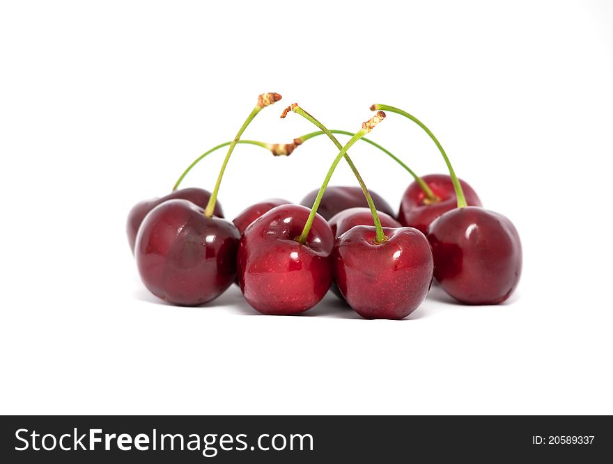 Red cherries with stems on white background