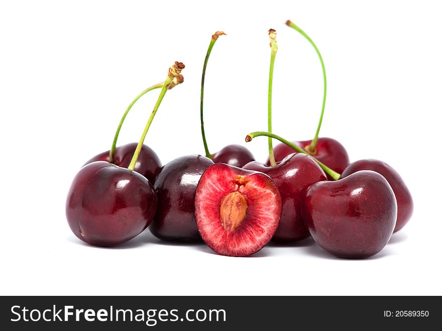Eight red cherries and a half with stems on white background. Eight red cherries and a half with stems on white background