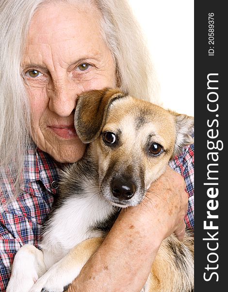 Beautiful senior woman holding her cute mixed breed puppy. Beautiful senior woman holding her cute mixed breed puppy