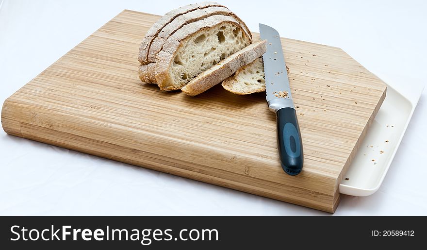 Bread with knife on a cutting board. Bread with knife on a cutting board