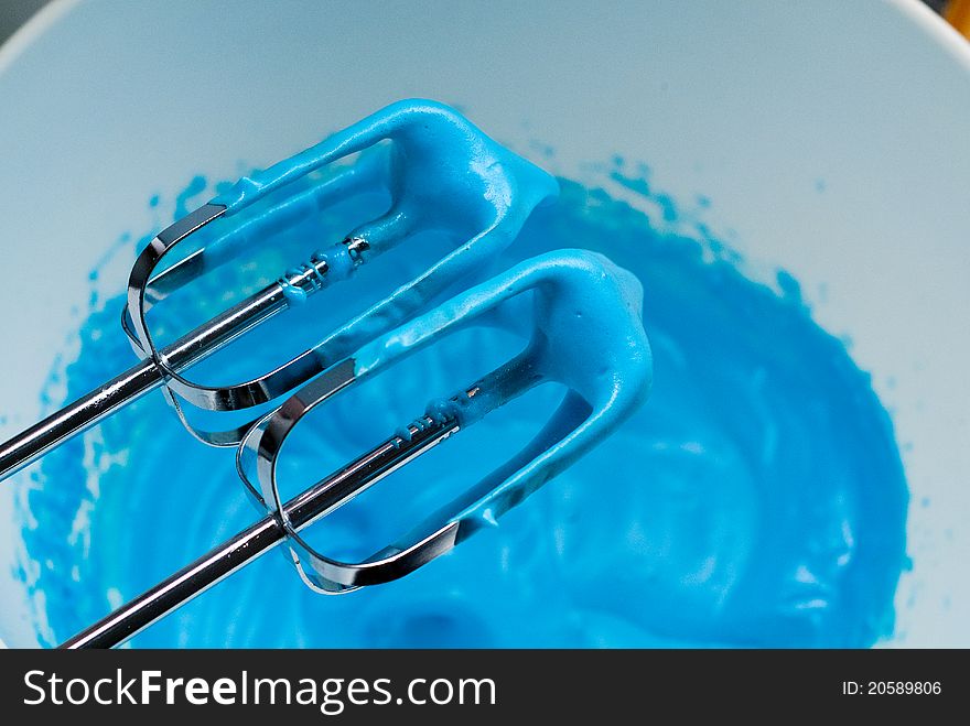 Mixer blades and bowl of blue meringue. Mixer blades and bowl of blue meringue.