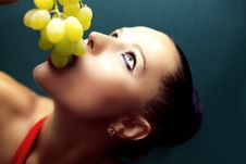 Young Woman Eating Grapes. Stock Images