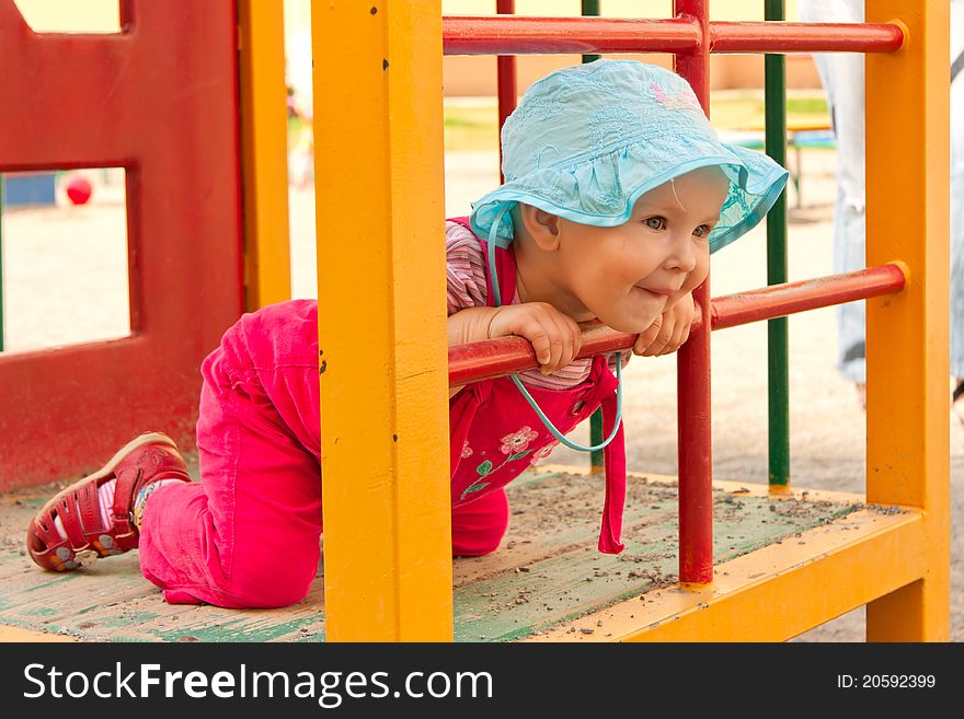 Little girl on playground,smiling girl looking to somebody