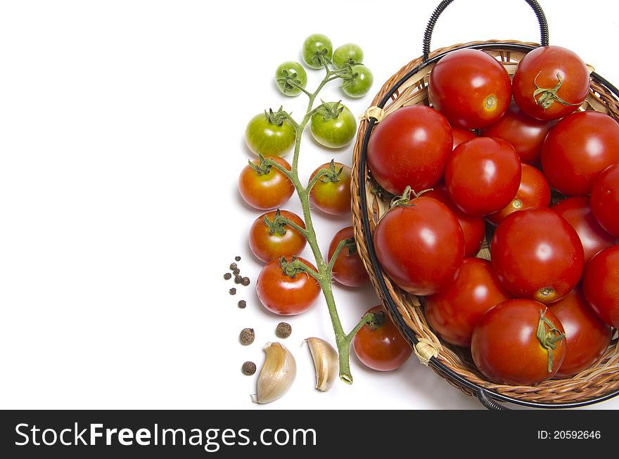 Tomatoes in basket on white background