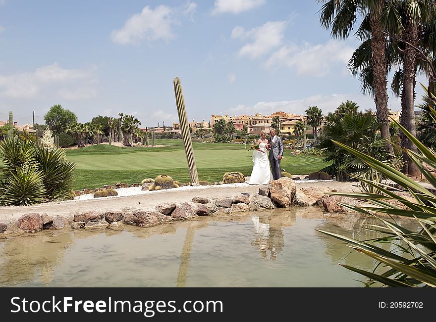 Bride and Groom in the sunshine at the reception at a golf course