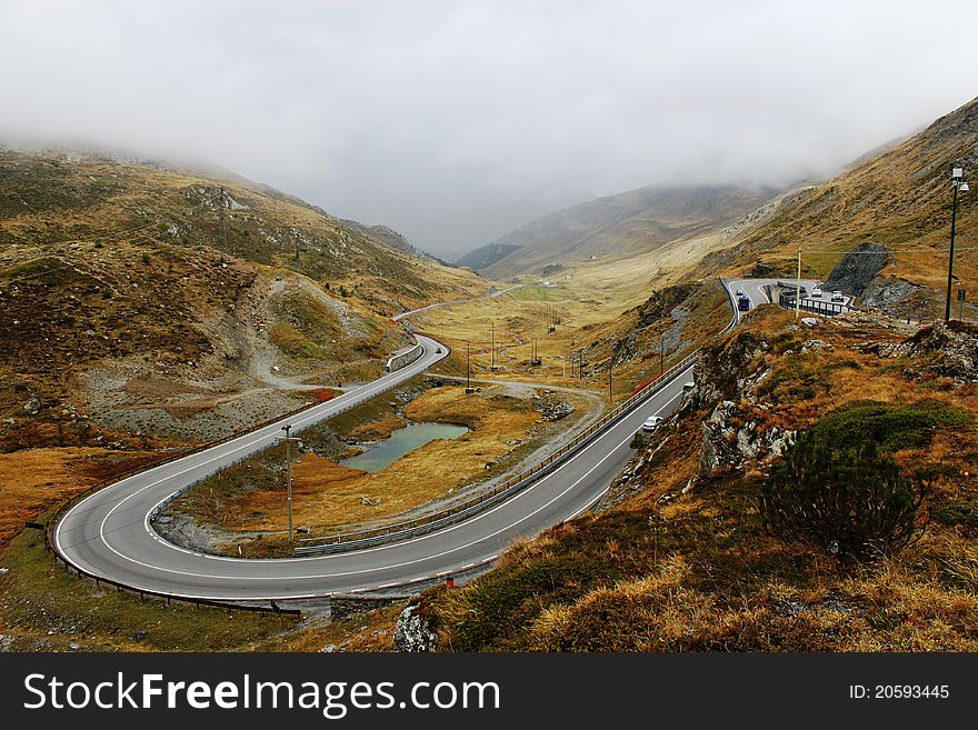 Serpentine Road In Autumn Alps