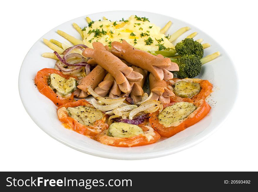 Cooked wieners with mashed potato and barbecued tomato cucumber cheese slices, and fried red onions.  Isolated on white. Cooked wieners with mashed potato and barbecued tomato cucumber cheese slices, and fried red onions.  Isolated on white.