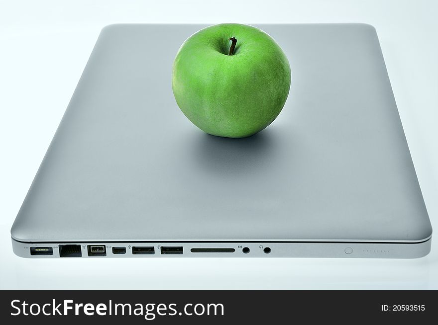 Laptop with green apple on the cover. Laptop with green apple on the cover.