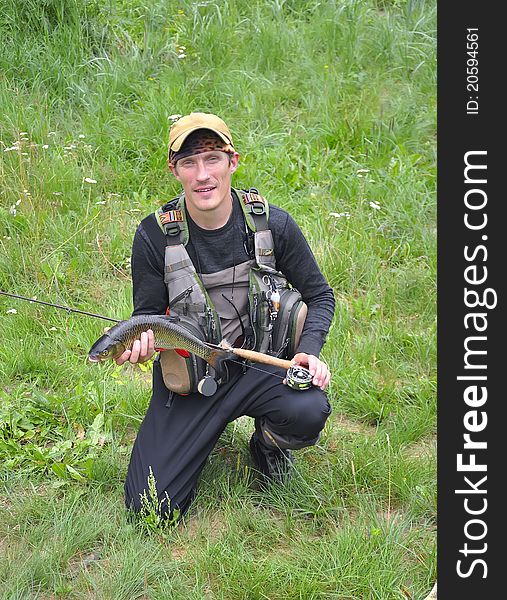 Fly fisher with chub