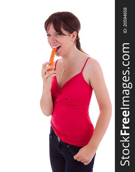 The pretty young woman biting into a carrot. The pretty young woman biting into a carrot