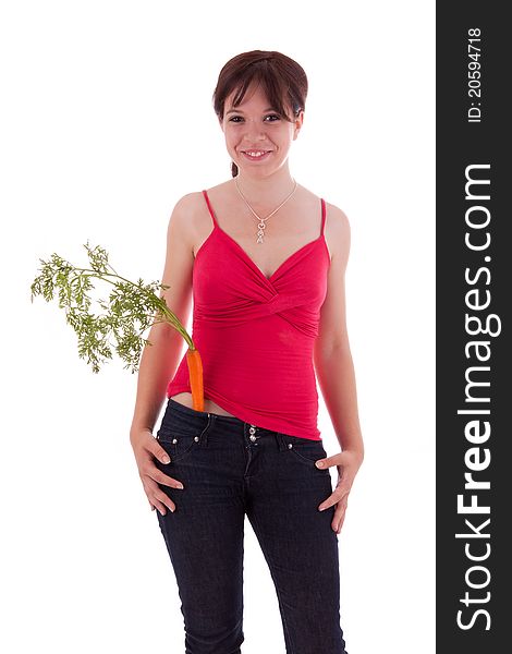 The young woman with a carrot in his trousers pockets. The young woman with a carrot in his trousers pockets