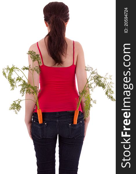 The young woman with a carrot in his trousers pockets. The young woman with a carrot in his trousers pockets