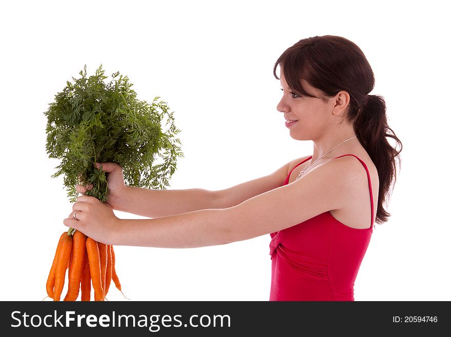 The young woman with a bunch of carrots in hand. The young woman with a bunch of carrots in hand