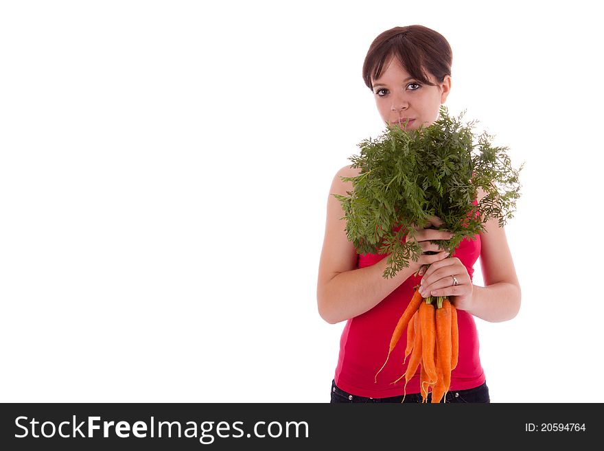 The young woman with a bunch of carrots in hand. The young woman with a bunch of carrots in hand