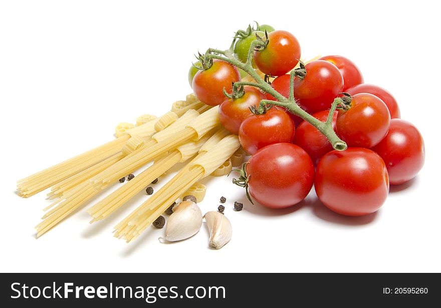 Tomatoes and pasta with spice on white background