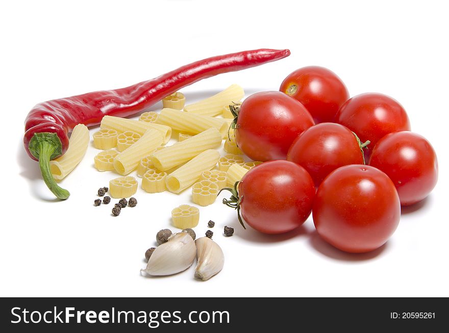 Tomatoes and pasta with spice on white background