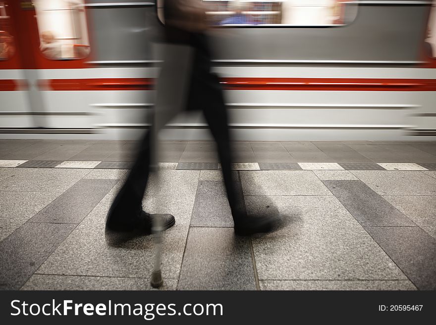 Old man is going to subway - blurred motion