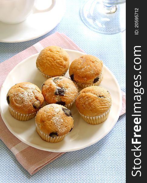 Muffin with chocolate on plate