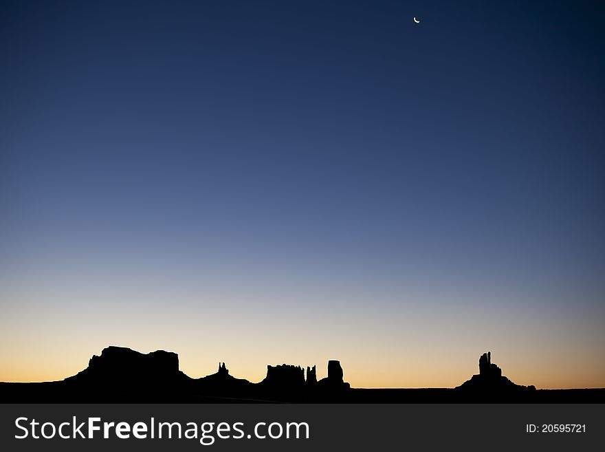 This is a picture of monument valley taken from a distance. The silhouette of the Sentinel Mesa, East Mitten, West Mitten, Merrick Butte and Elephant Butte can be seen. This is a picture of monument valley taken from a distance. The silhouette of the Sentinel Mesa, East Mitten, West Mitten, Merrick Butte and Elephant Butte can be seen.