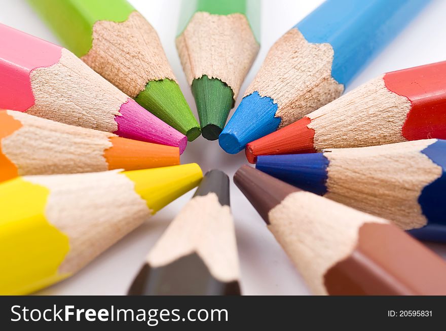 Color pencils in arrange in color wheel colors on white background