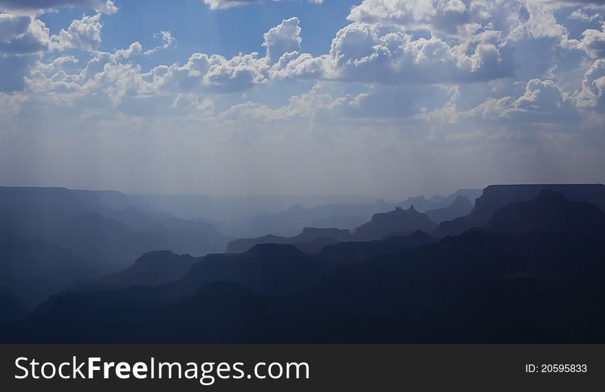 This is taken from the grand canyon south rim. This show the ridges of mountain in a distance. The fog is reducing the visibility of distance mountain giving it a nice gradient of colour. This is taken from the grand canyon south rim. This show the ridges of mountain in a distance. The fog is reducing the visibility of distance mountain giving it a nice gradient of colour.