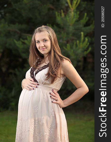 Pregnant woman on green background