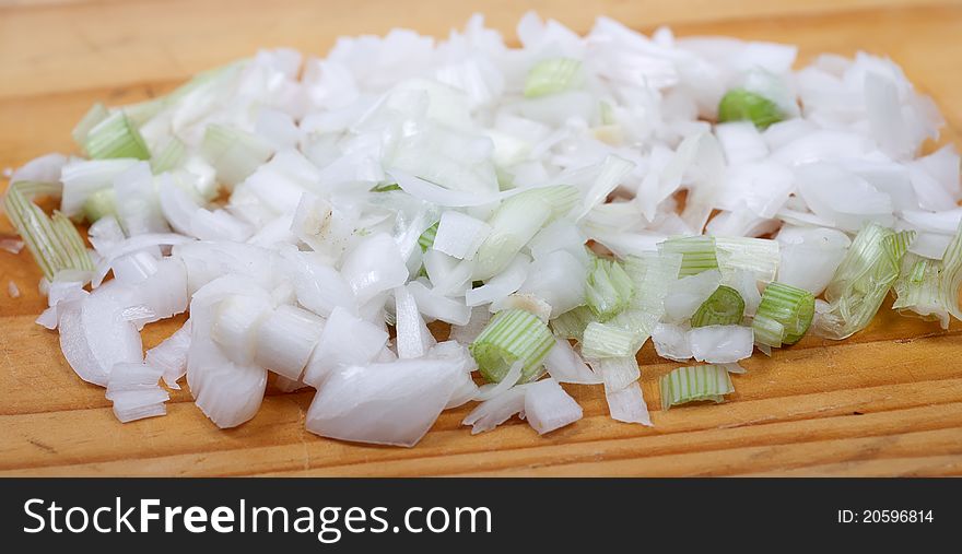 Diced green onions from above on dice board