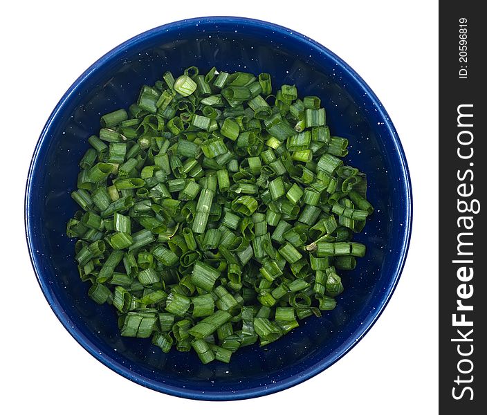 Studio shot of diced green onions in bowl on white background