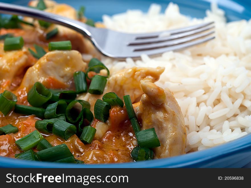 Studio shot of Peanut butter chicken and rice meal on white background
